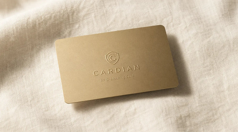 Cardian RFID-blocking card on a cream linen surface, soft natural light.